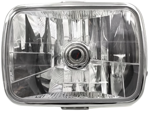 Car headlight with clear lens and metallic frame on a white background