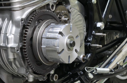 Close-up of a motorcycle engine with gears and metal components.
