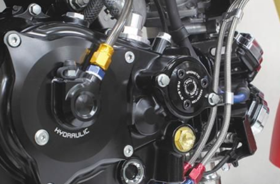Close-up of a motorcycle's hydraulic system with visible branding.