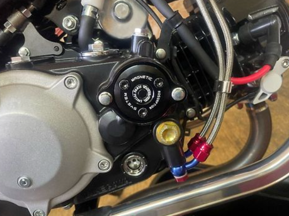 Close-up of a motorcycle engine with visible components and wiring.