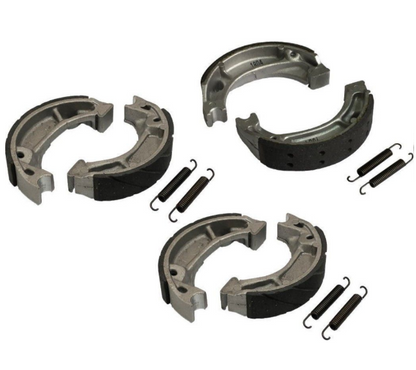 Set of brake shoe and spring components on a white background