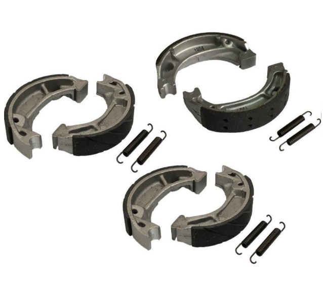 Set of brake shoe and spring components on a white background