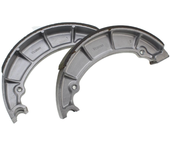 Two metallic brake shoes on a white background