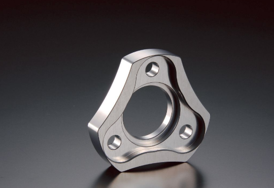 Metallic mechanical component on a dark background