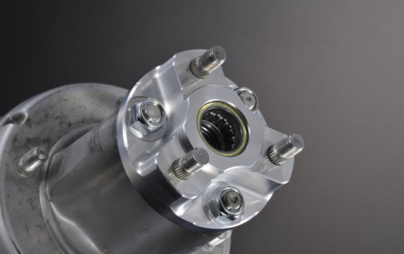 Close-up of a metallic mechanical component with bolts on a dark background