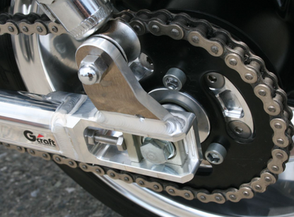 Close-up of a motorcycle chain and sprocket with 'Gaertt' branding.