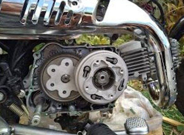 Close-up of a motorcycle engine with visible mechanical components.