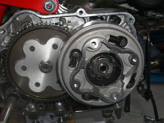 Close-up of a mechanical engine component with gears and metal parts.