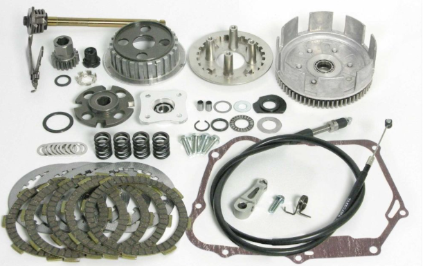 Mechanical parts including gears, springs, and clutch plates on a white background