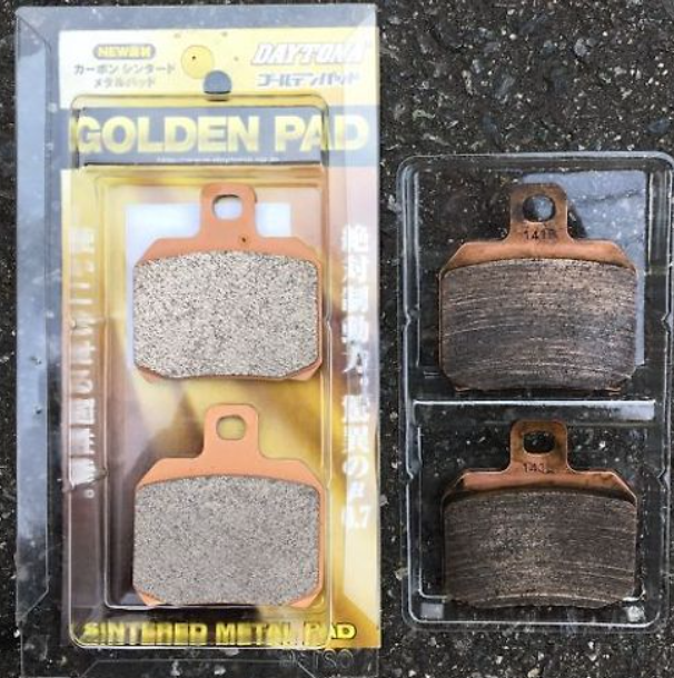 Brake pads with packaging on a dark textured surface