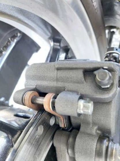Close-up of a motorcycle brake system with metallic components.