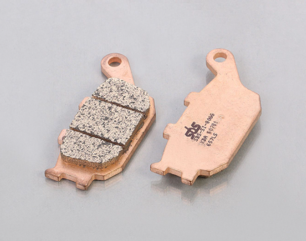 Two brake pads on a gray background