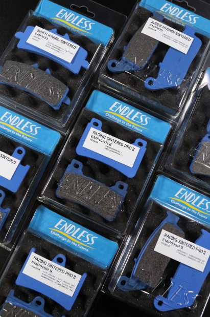 Packaged brake pads with Endless branding on a black background