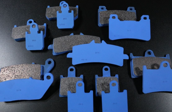 Collection of brake pads with blue and gray colors on a dark background