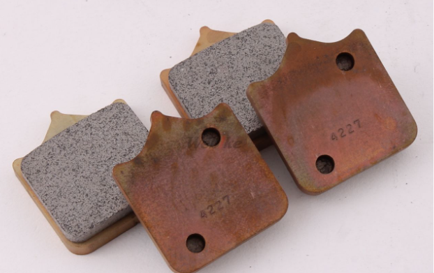Four brake pads on a white background