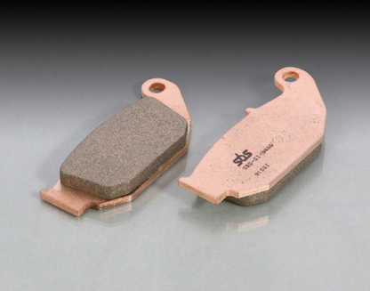 Two brake pads on a gray background
