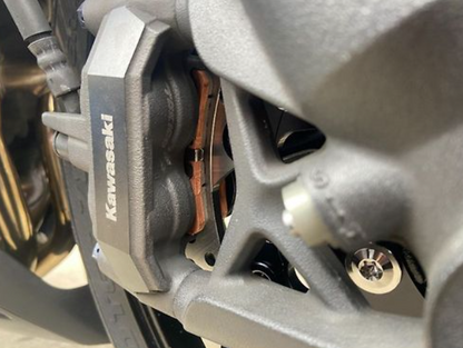 Close-up of a Kawasaki brake pad on a motorcycle.