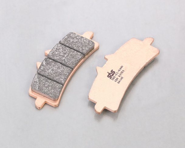 Two brake pads on a gray background