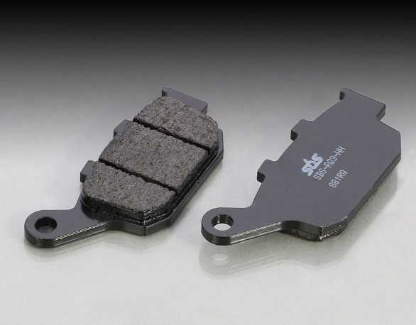Two brake pads on a gray background