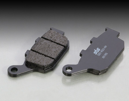 Two brake pads on a gray background