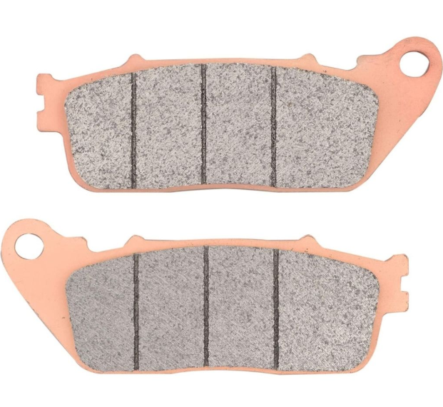 Two brake pads with pink metal backing on a white background