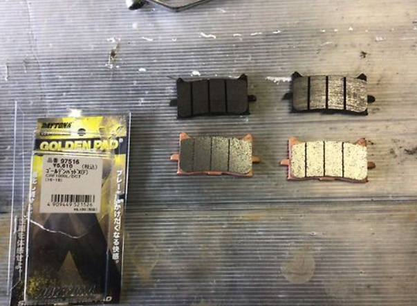 Brake pads with packaging on a corrugated metal surface