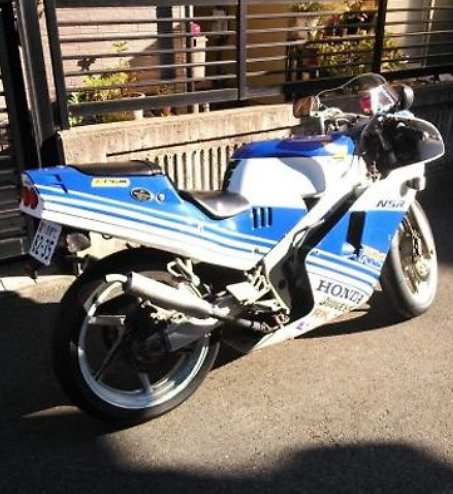 Blue and white Honda motorcycle parked on a street