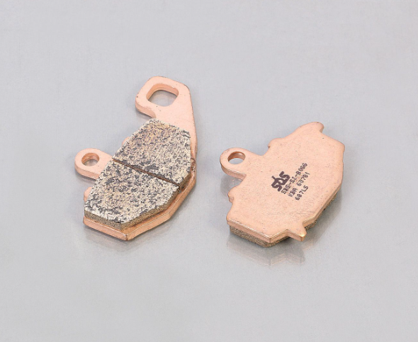 Two brake pads on a gray background