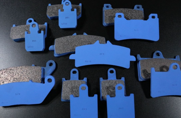 Set of brake pads with blue and gray color on a dark background