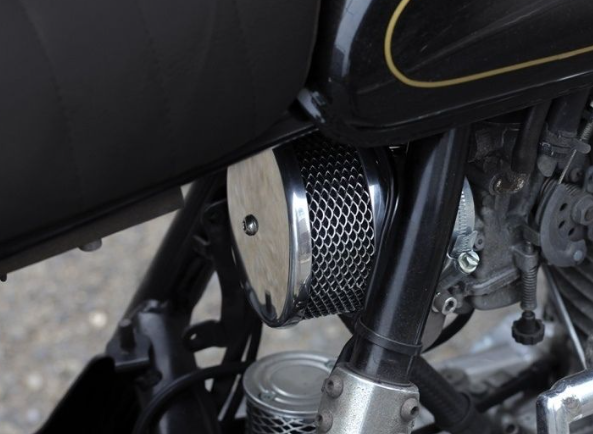 Close-up of a motorcycle exhaust and engine components.