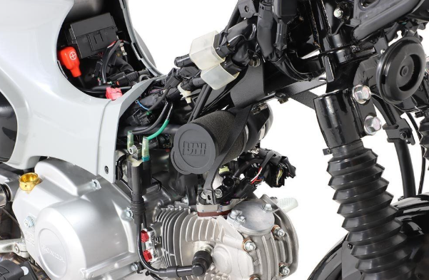 Close-up of a motorcycle engine and mechanical components on a white background