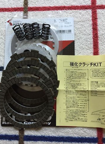 Clutch kit with springs and documentation on a checkered fabric background