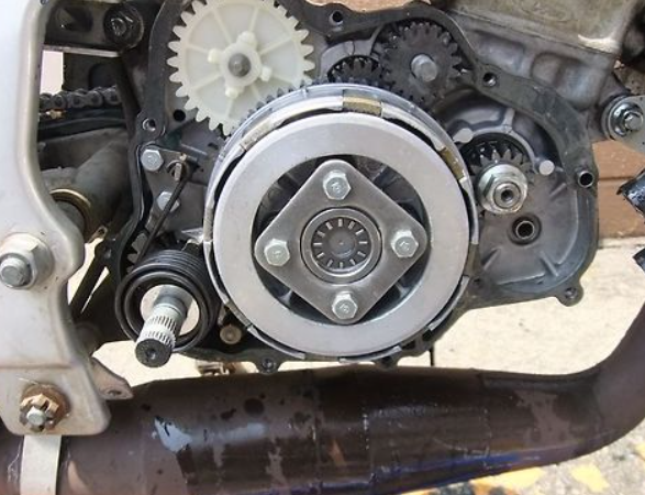 Close-up of a mechanical engine component with gears and bearings.