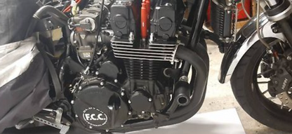 Close-up of a motorcycle engine with 'F.C.C.' branding.