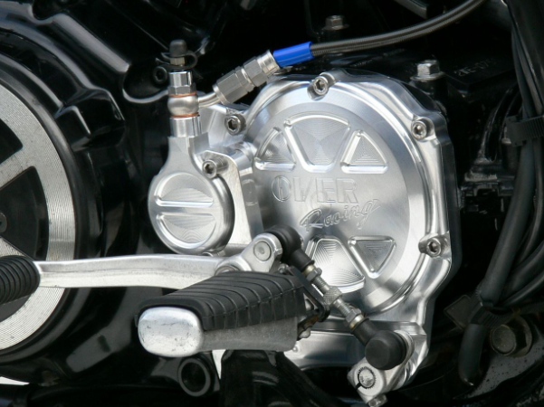 Close-up of a motorcycle engine with a brand logo on a black background