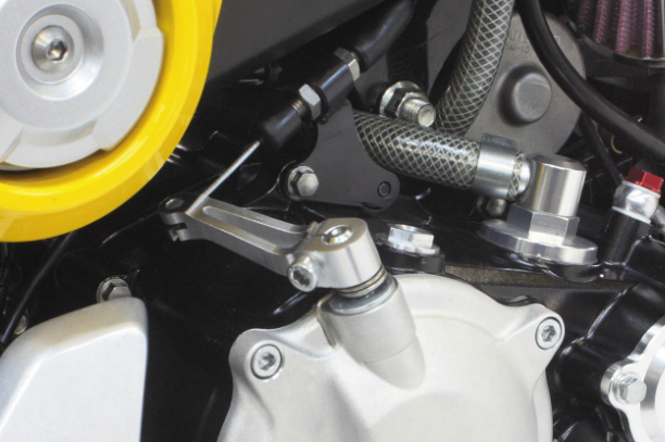 Close-up of a motorcycle's engine and components with a focus on mechanical parts.