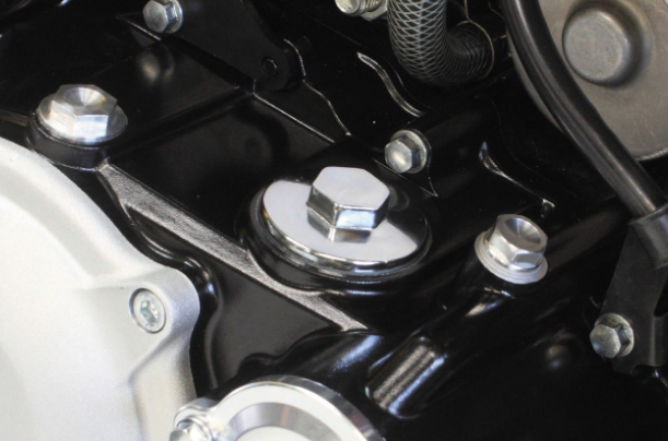 Close-up of a mechanical component with bolts and nuts on a dark background