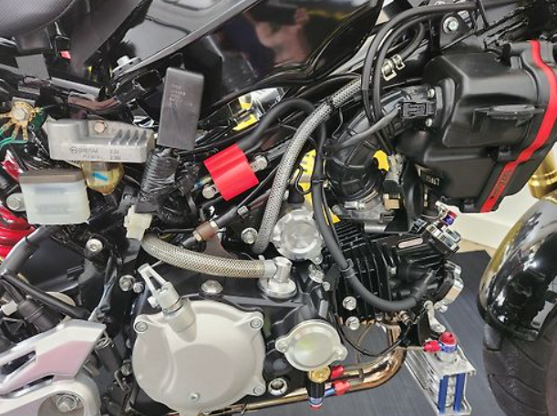 Close-up of a motorcycle engine with visible branding