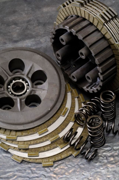 Clutch plates, springs, and pressure plate on a metallic surface