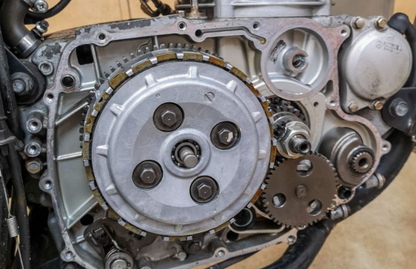 Close-up of a mechanical engine component with gears and metal parts.