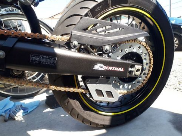 Close-up of a motorcycle chain and sprocket with 'Continental' branding.