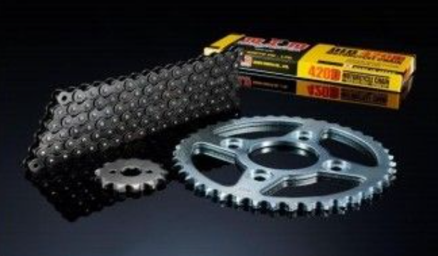 Motorcycle chain and sprocket set with a box on a dark background
