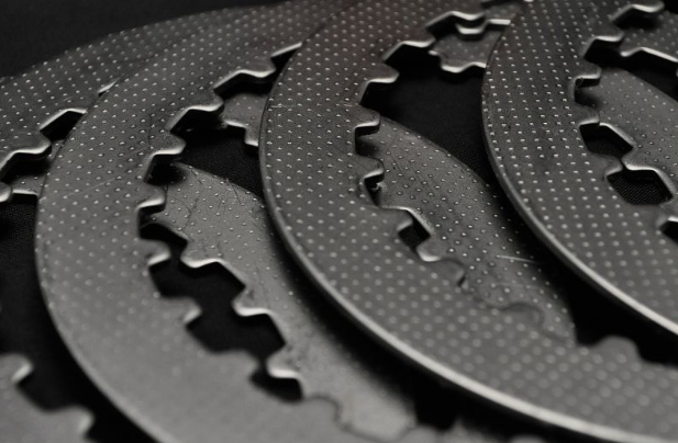 Close-up of black metal gear components on a dark background