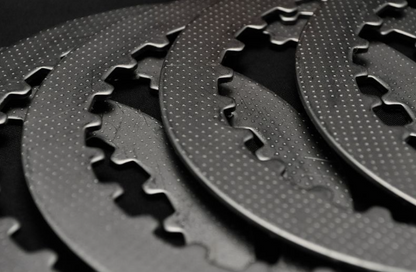 Close-up of black metal gear components on a dark background