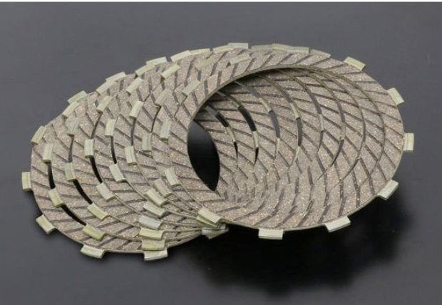 Two circular brake pads on a dark background