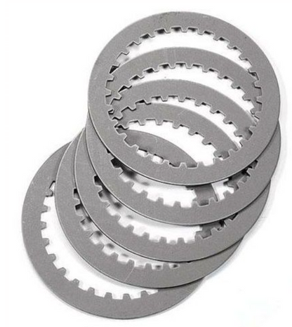 Stack of metallic clutch plates on a white background
