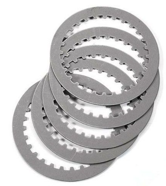 Stack of metallic clutch plates on a white background