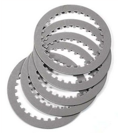 Stack of metallic clutch plates on a white background
