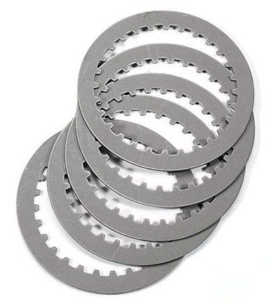 Stack of metallic clutch plates on a white background
