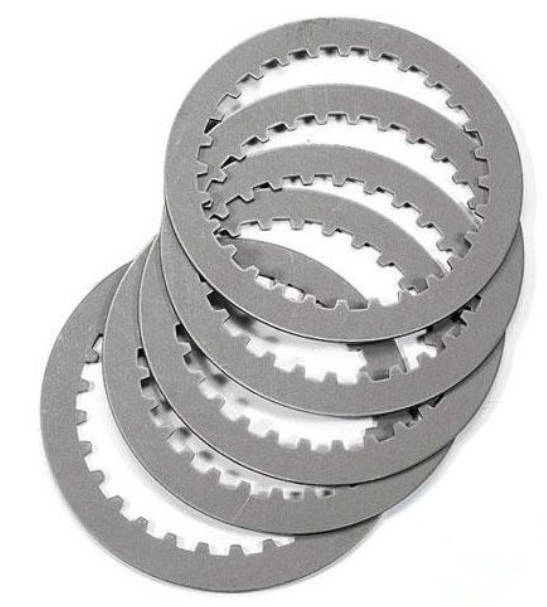 Stack of metallic clutch plates on a white background